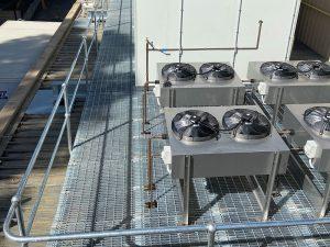 A roof plant platform with industrial exhausts and aircon.