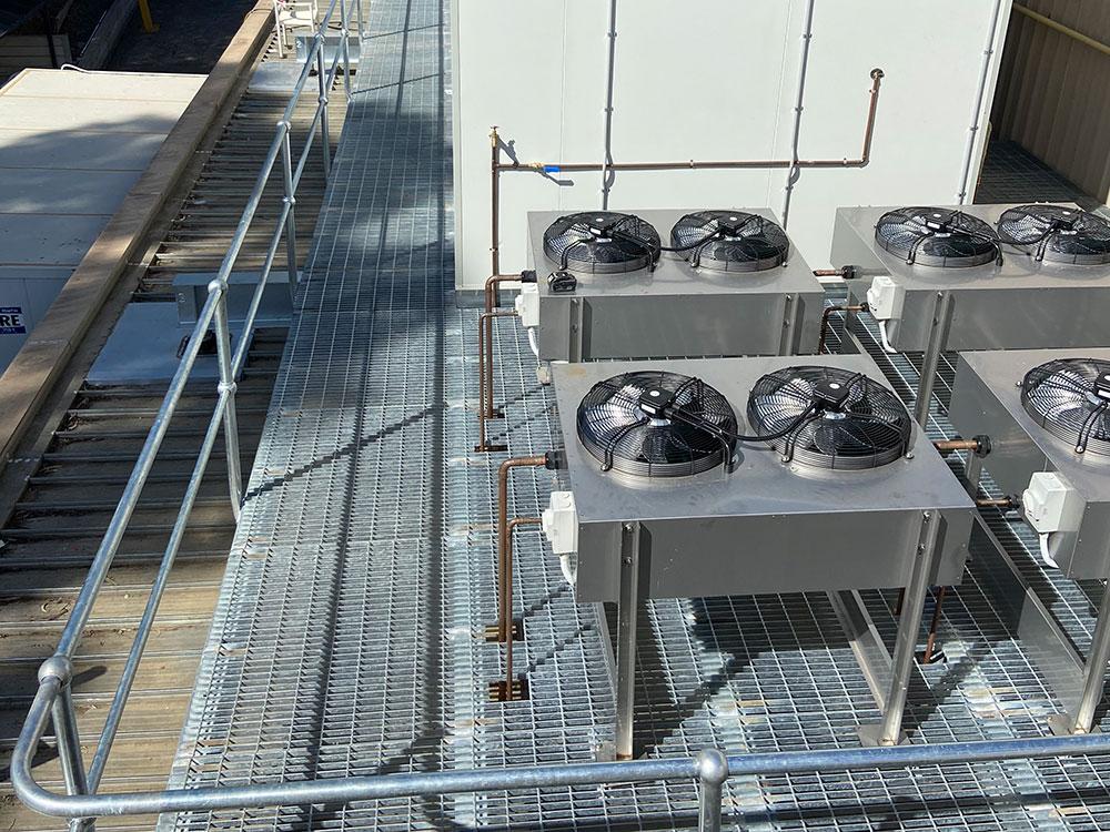 A roof plant platform with industrial exhausts and aircon.