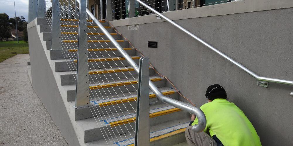 man finishing handrails and balustrades, handrails in melbourne, Melbourne handrails and balustrades, Mechcon