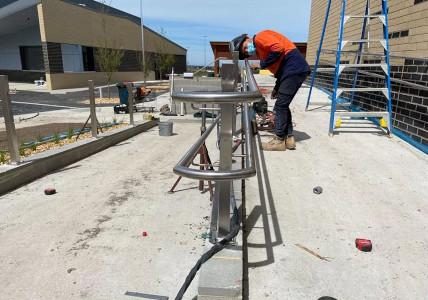 Mechcon staff installing stainless steel hand rails.